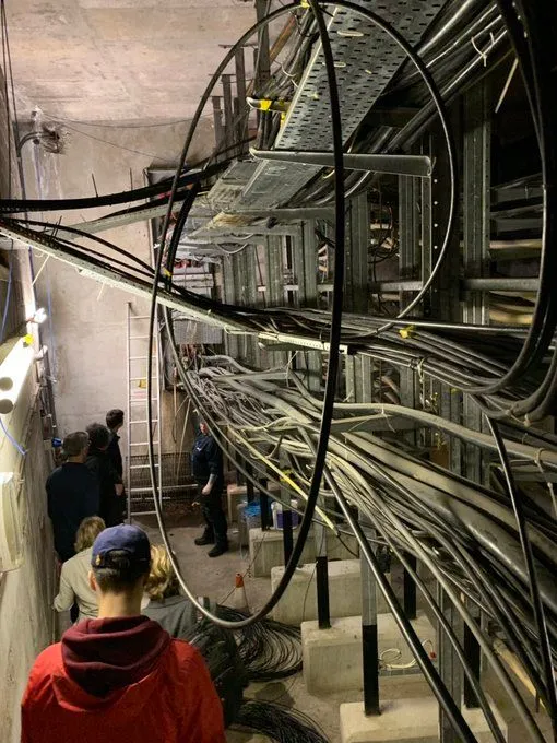 Copper and fibre cables entering the building from street level.