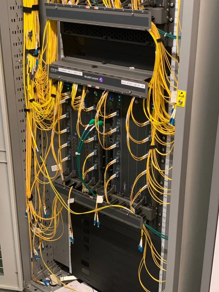 Yellow fibre cables and the Alcatel-Lucent router carrying half of Manchester's IP traffic.
